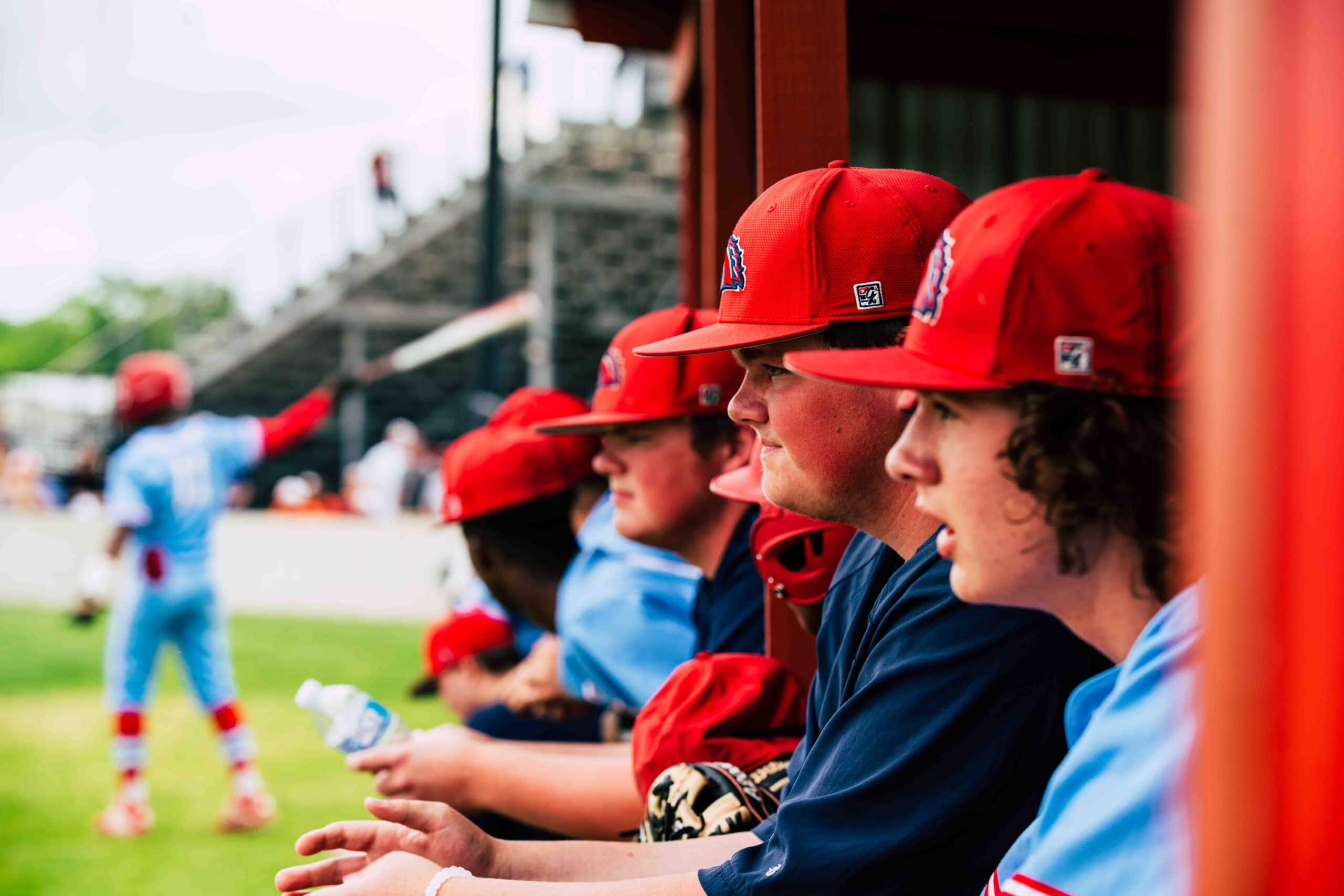 Baseball players watch game