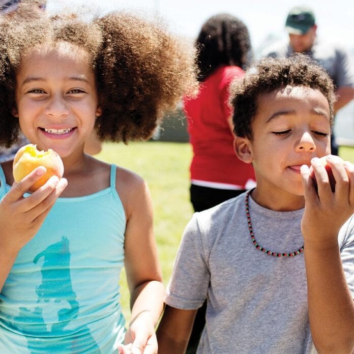 Kids eating peaches