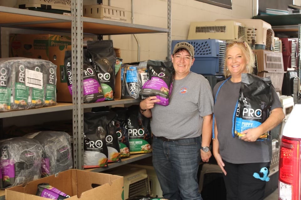 ladies holding pet food