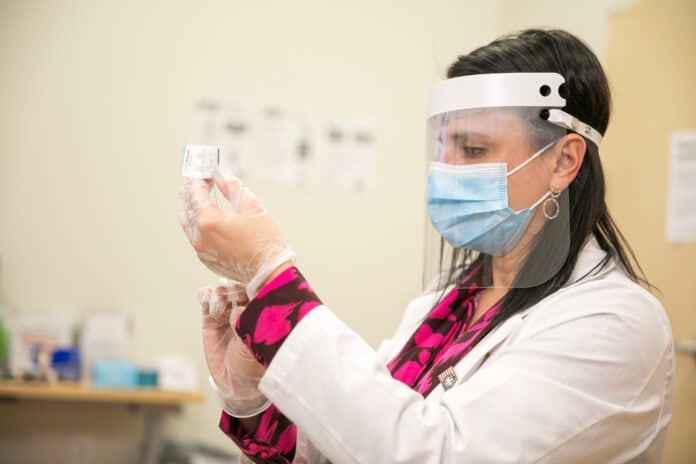 Pharmacist with face mask and face shield