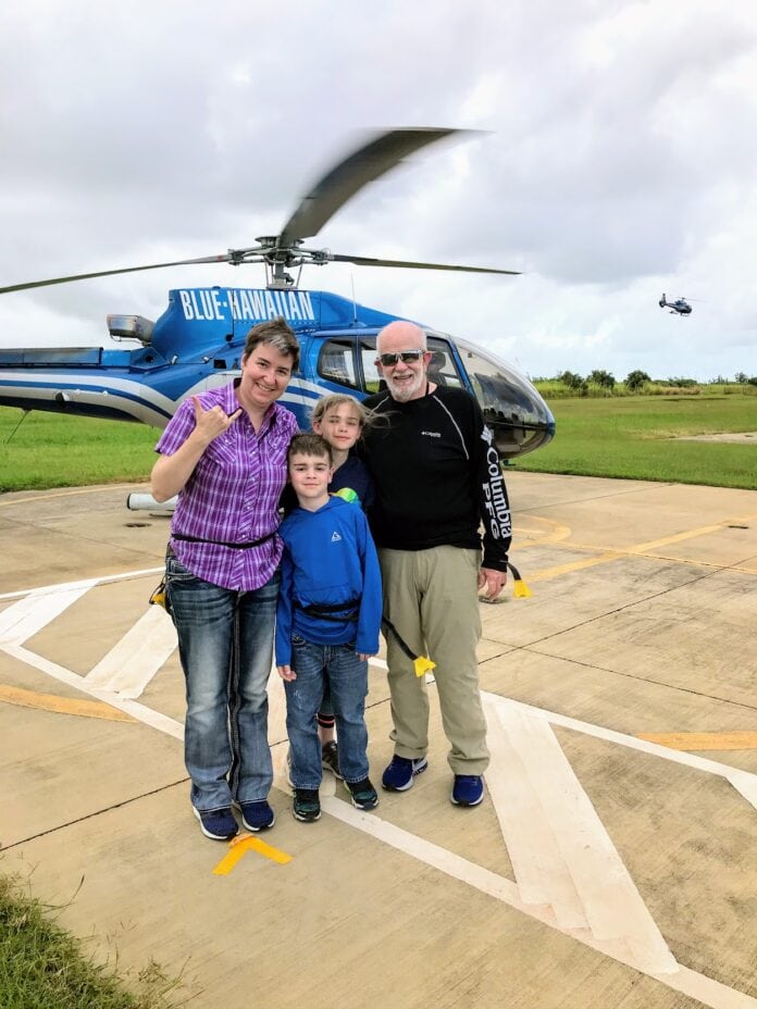 family standing in front of helicopter