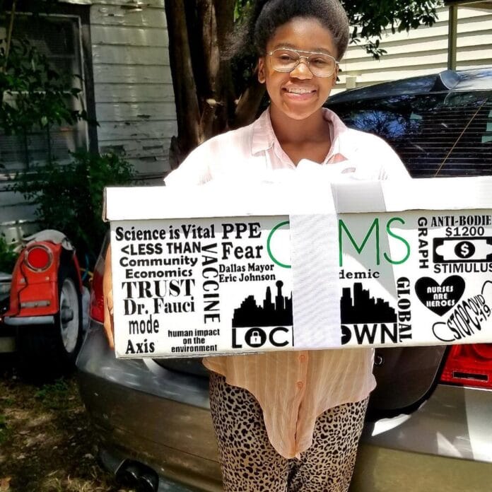 girl holding a sign