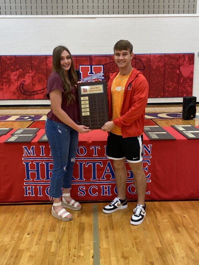 HHS boy and girl hold plaque