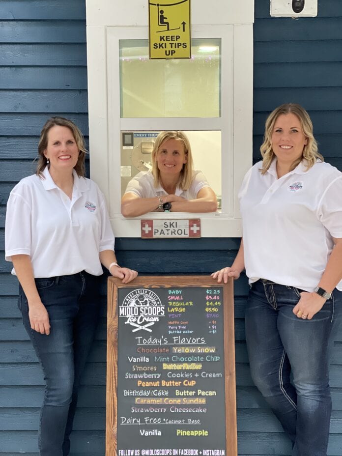 three ladies in front of window