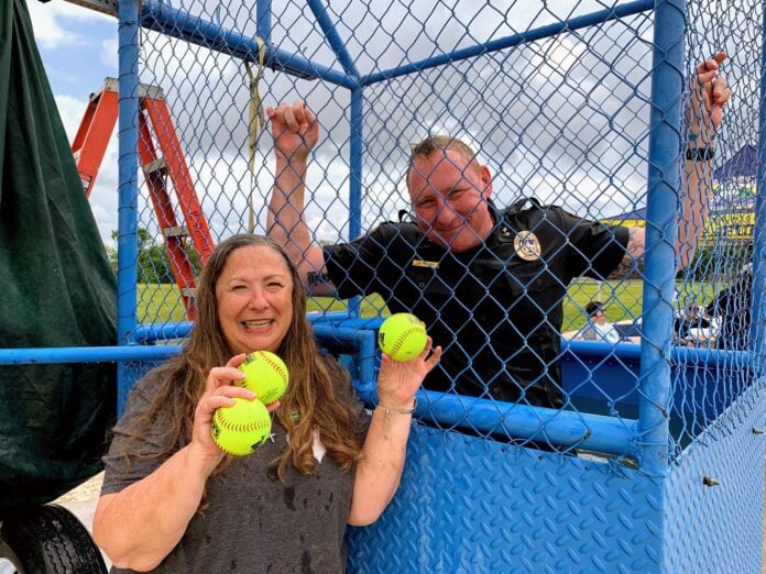 lady and police officer holding balls