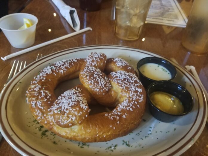 pretzel on plate with dipping sauces