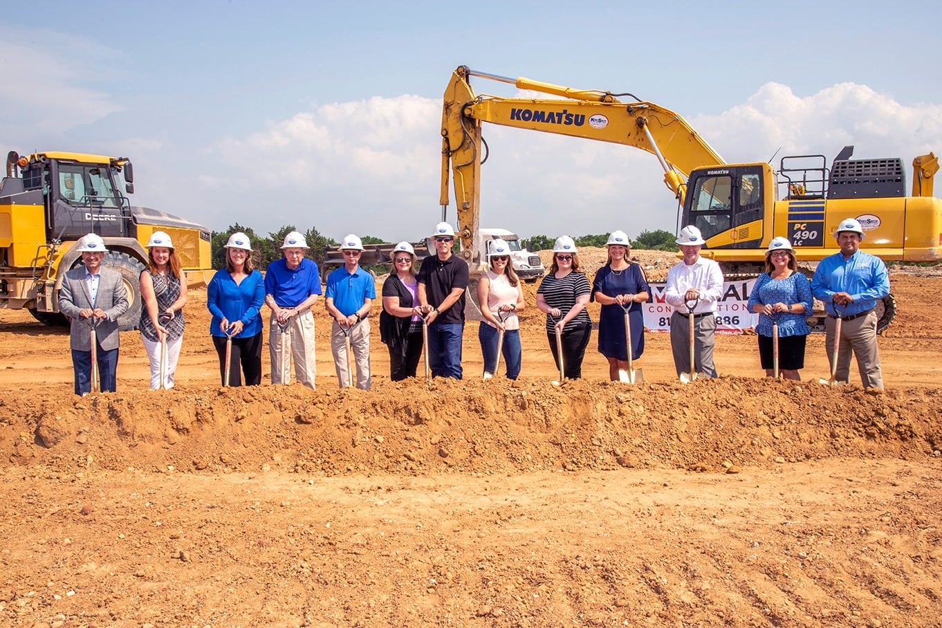 people wearing hardhats at groundbreaking