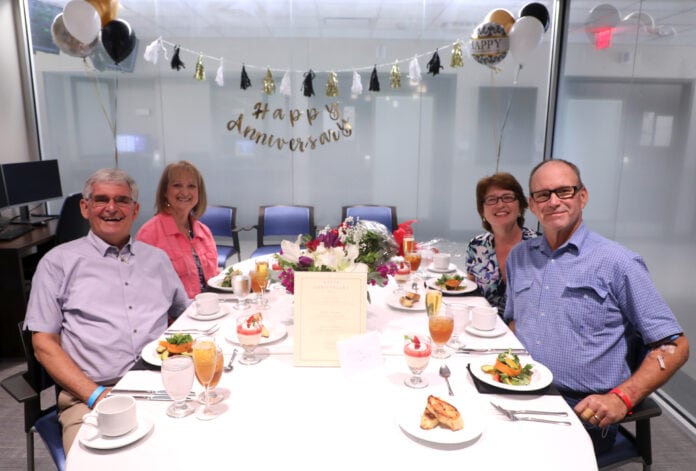 couples at a table with food