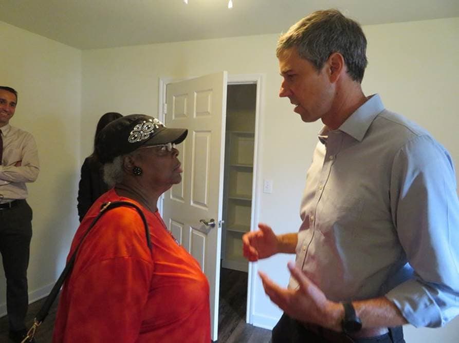 Beto speaks with lady in apartment