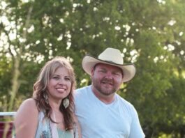 man and woman sitting on a truck tailgate