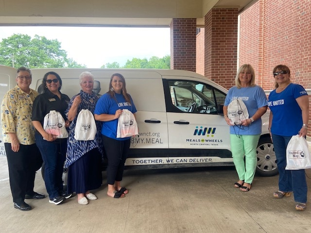 ladies standing in front of van