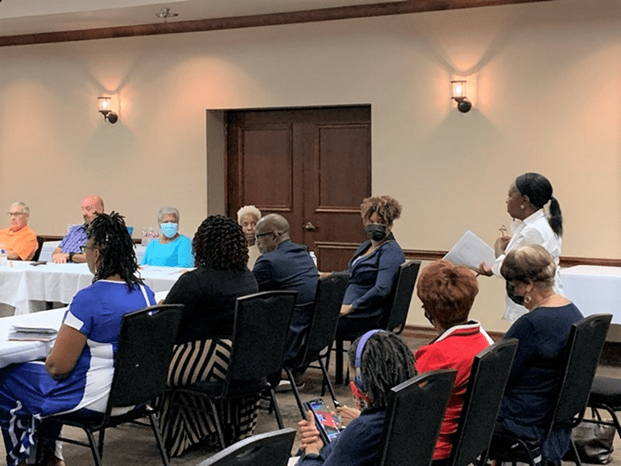 people in chairs in meeting room