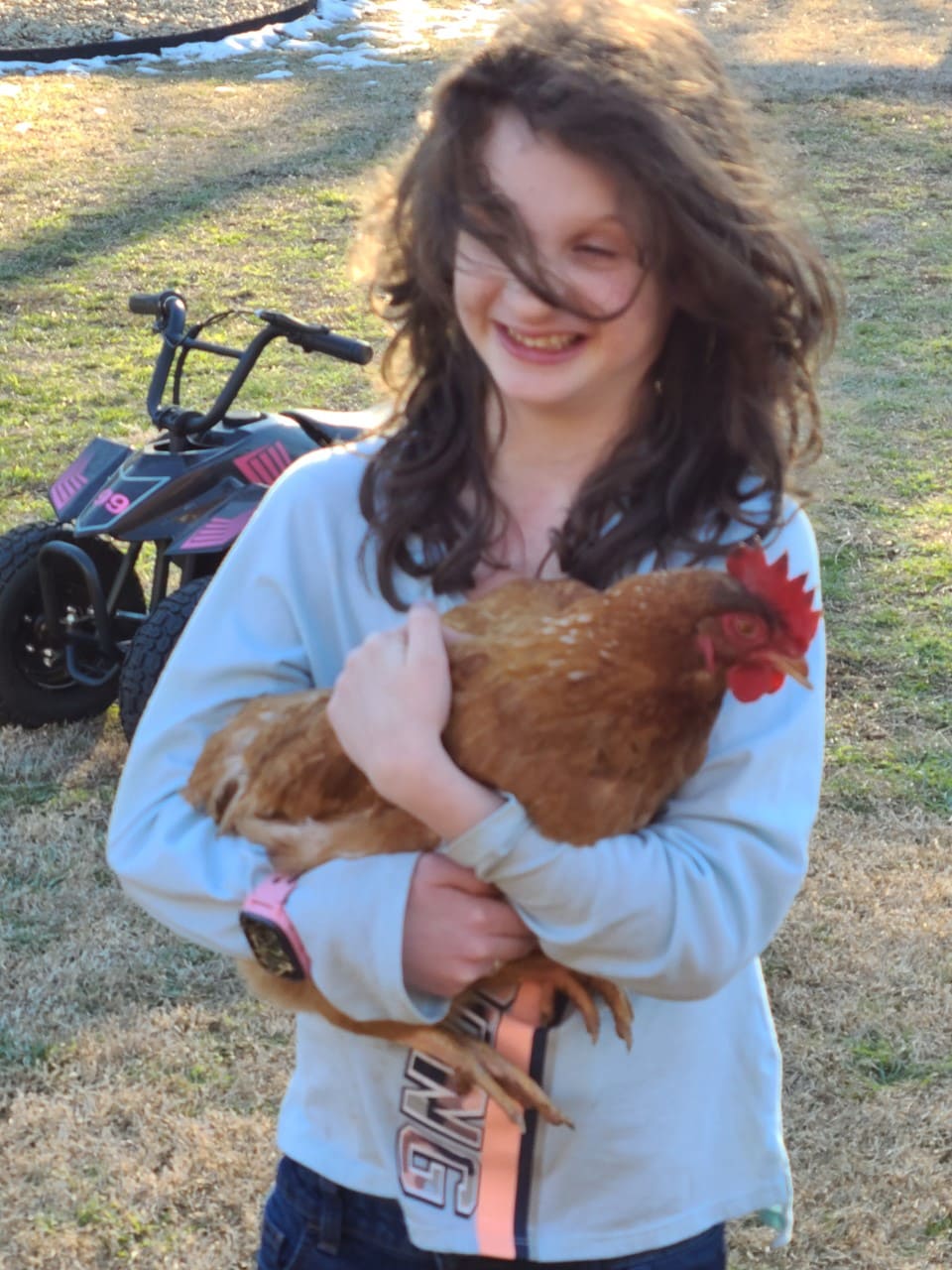 Rachel Derrick holding a rooster