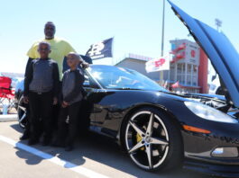 mand and kids standing by car