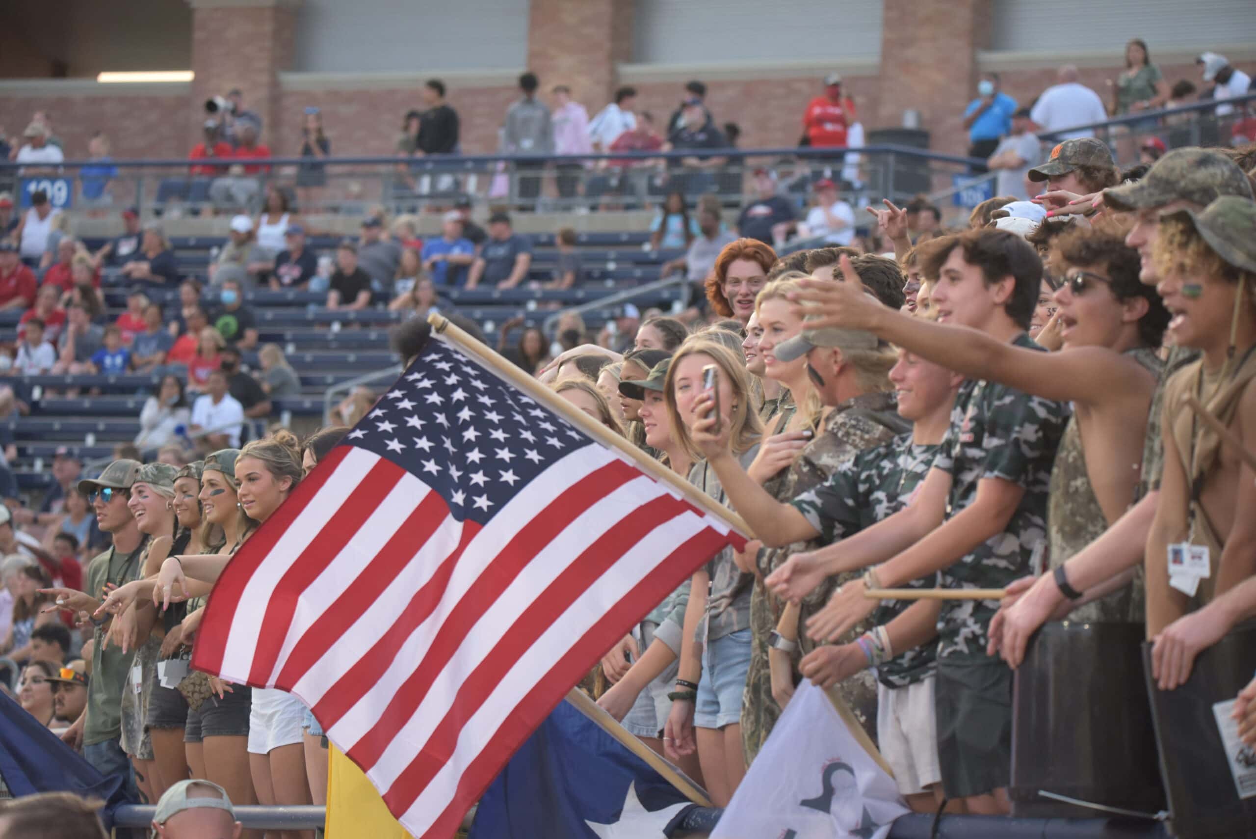 fans holding American flag