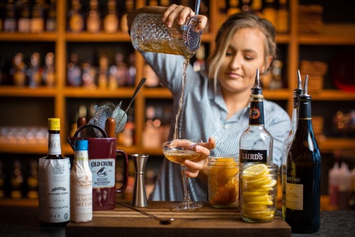 female bartended pouring drink