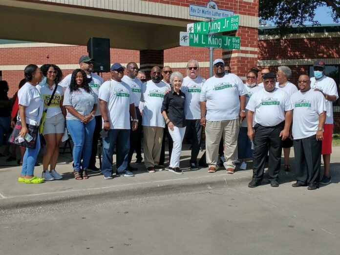 Dr. MLK Jr. Blvd dedication MLK Committee Group photo in front with Grand Prairie NAACP president Angela Luckey and Judge Kim Cooks MLK Committee group in front of street sign