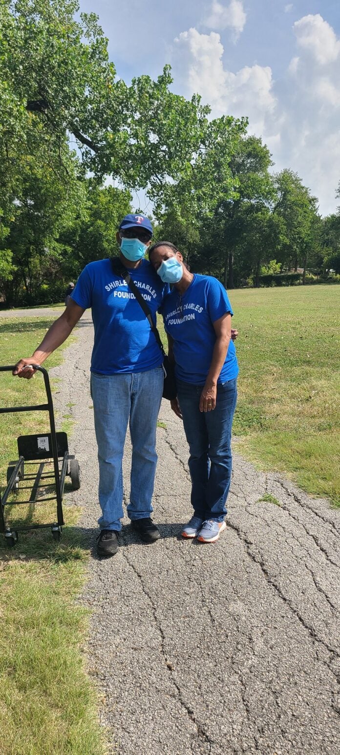 two people standing together with face masks