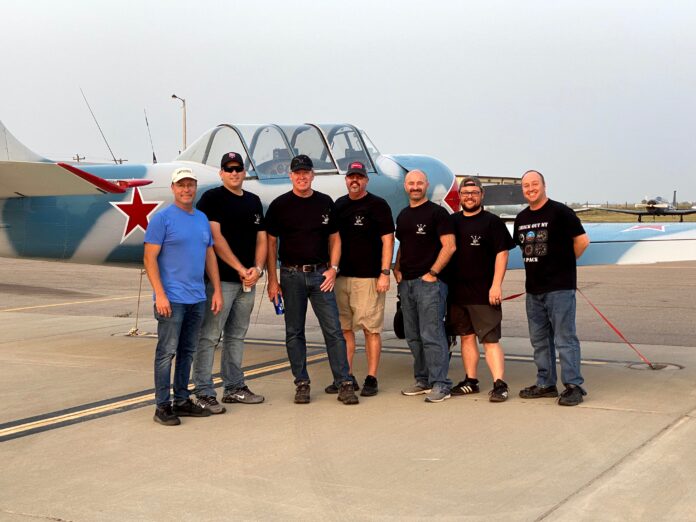 image0 (3) men standing in front of aircraft