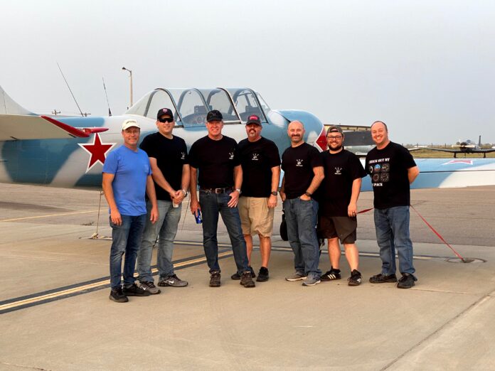 men standing in front of aircraft