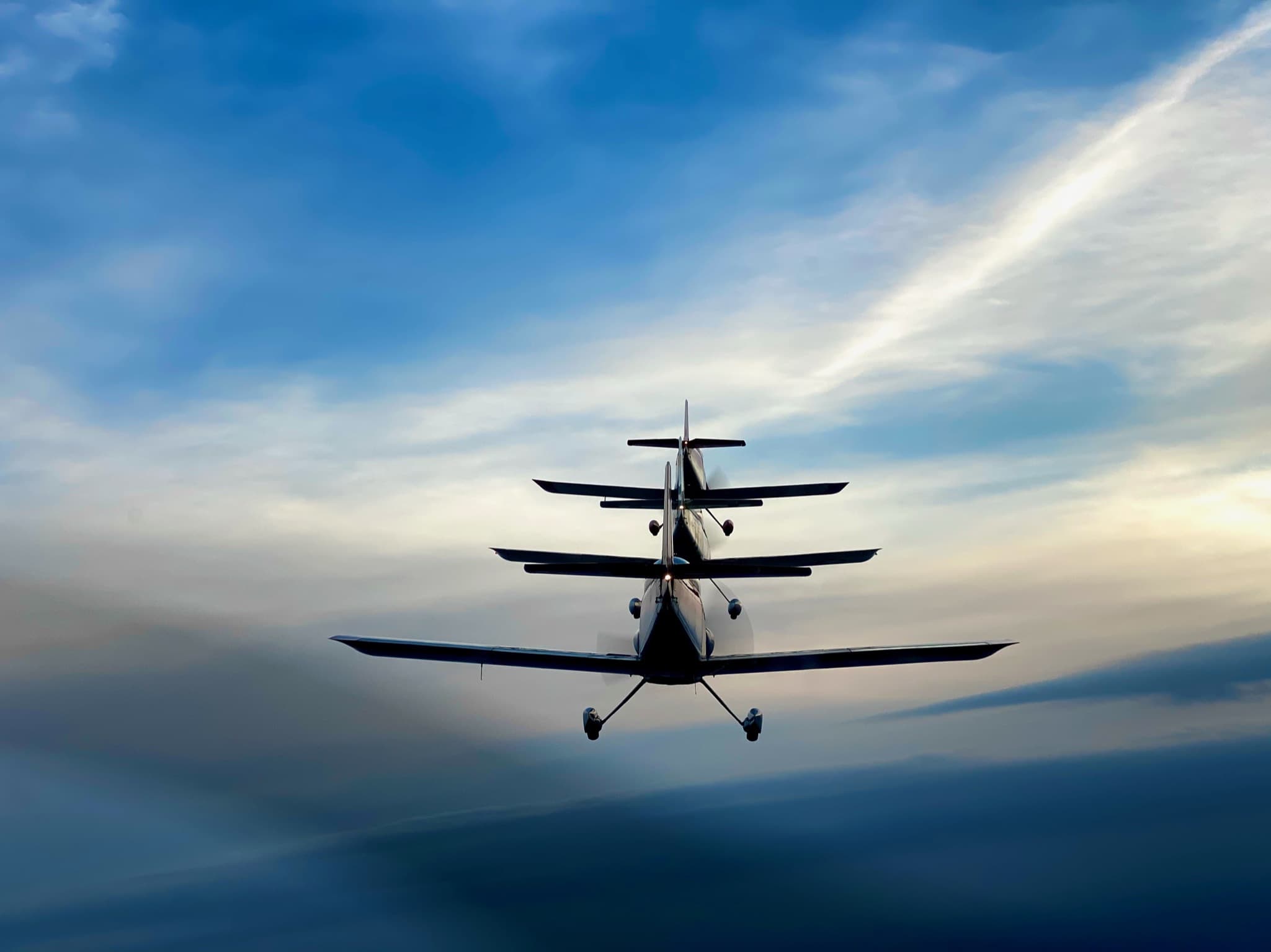 small planes flying in formation