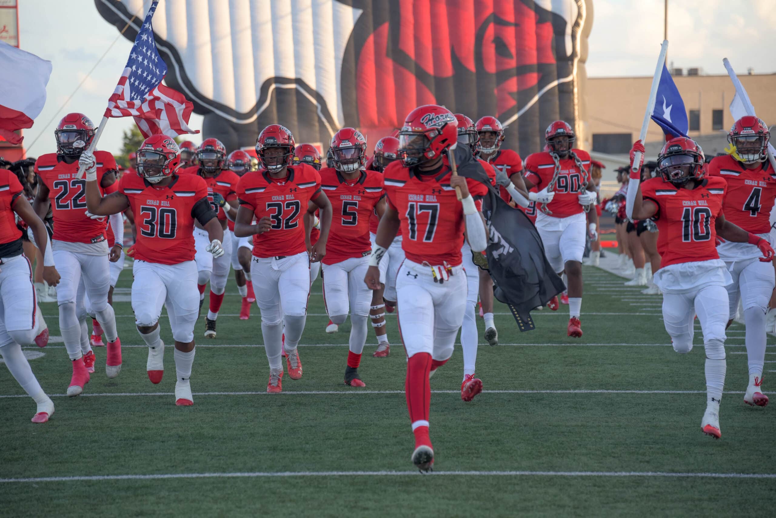 football players run onto field