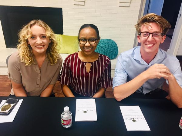 two girls and a boy at a table