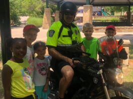 Police officer on motorcycle with children