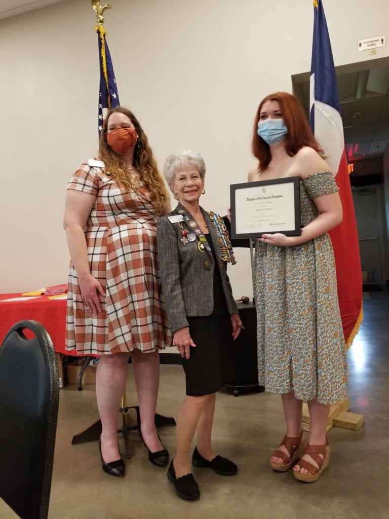 three ladies holding awards