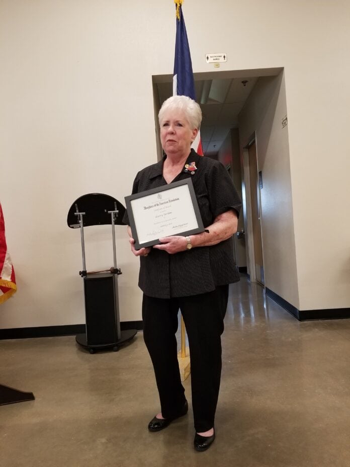 sherry perkins holding award