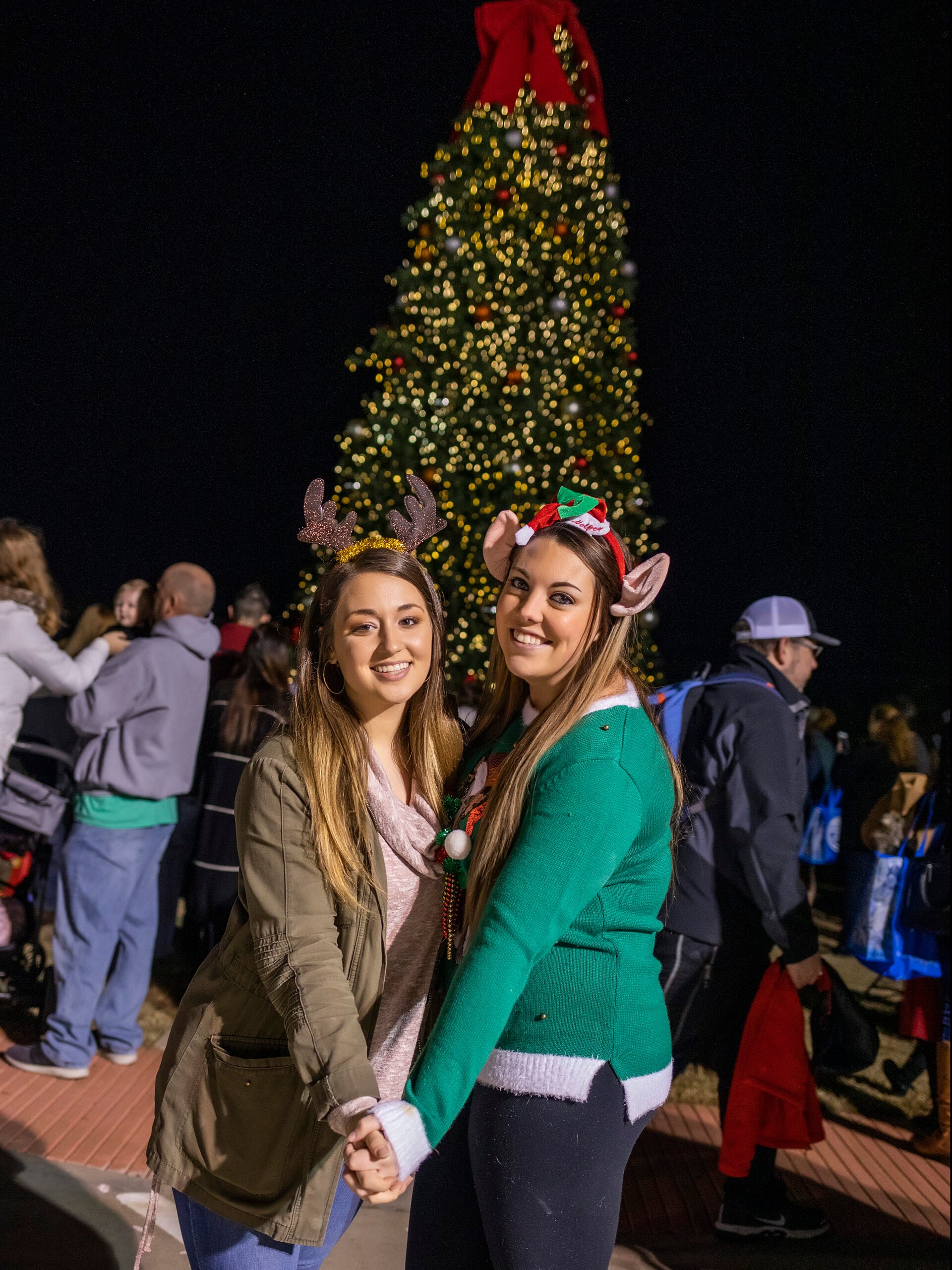two ladies by a Christmas tree