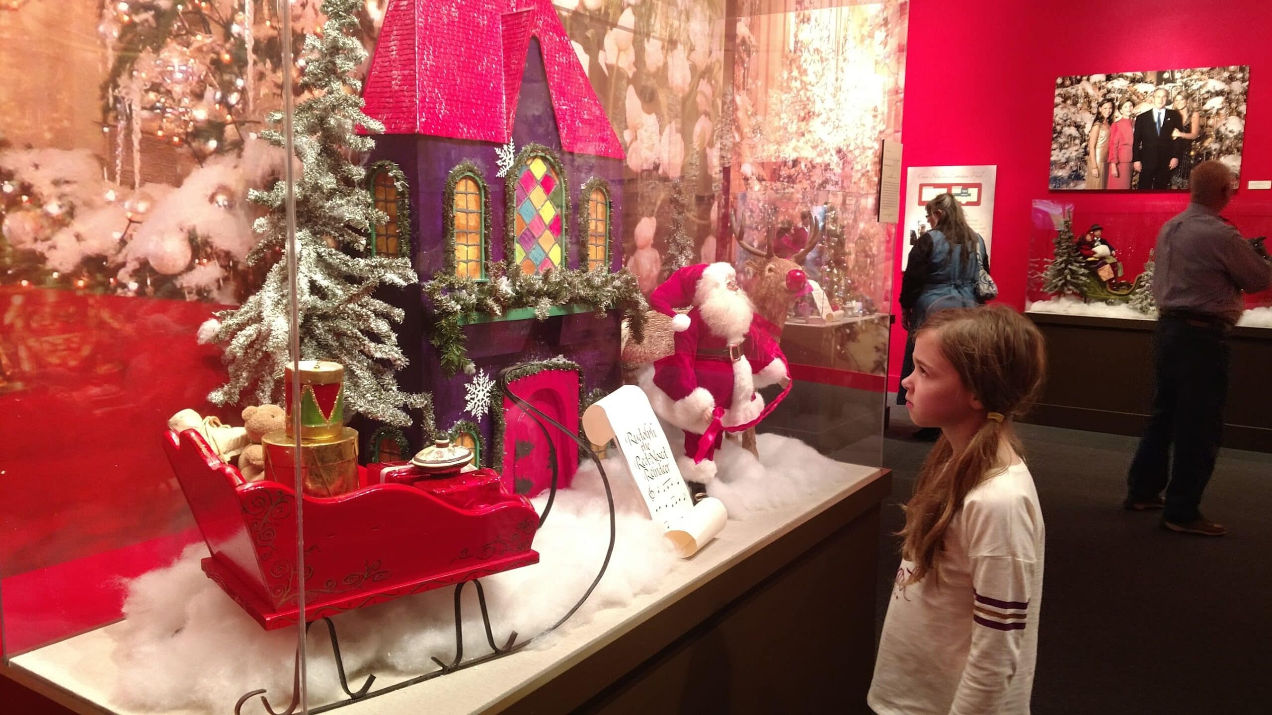 girl looking at Christmas decorations