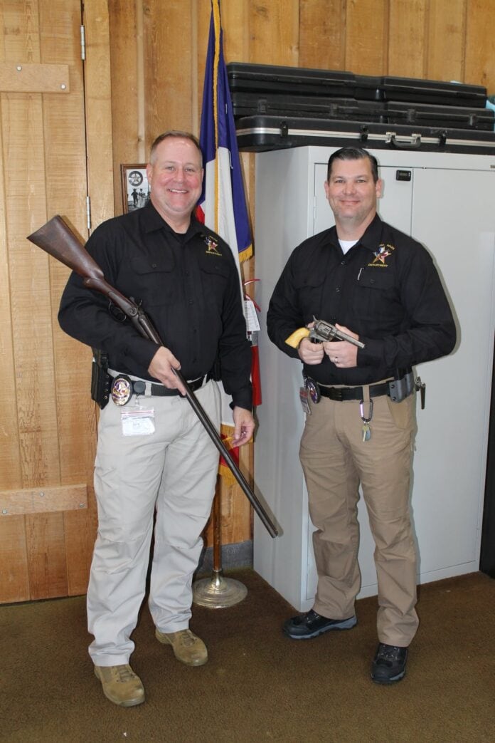 Two men holding weapons