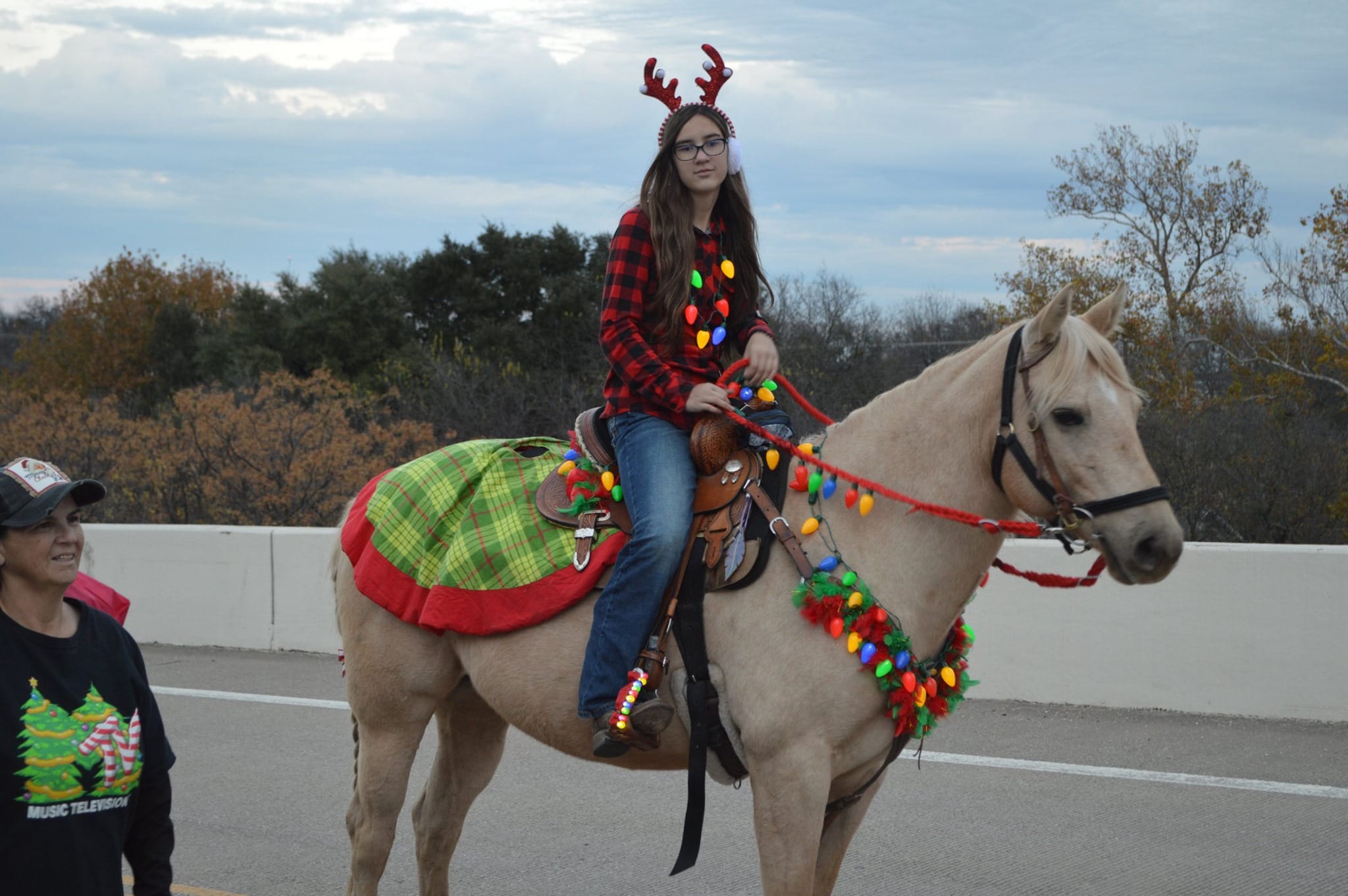 girl on horse wearing Christmas decorations