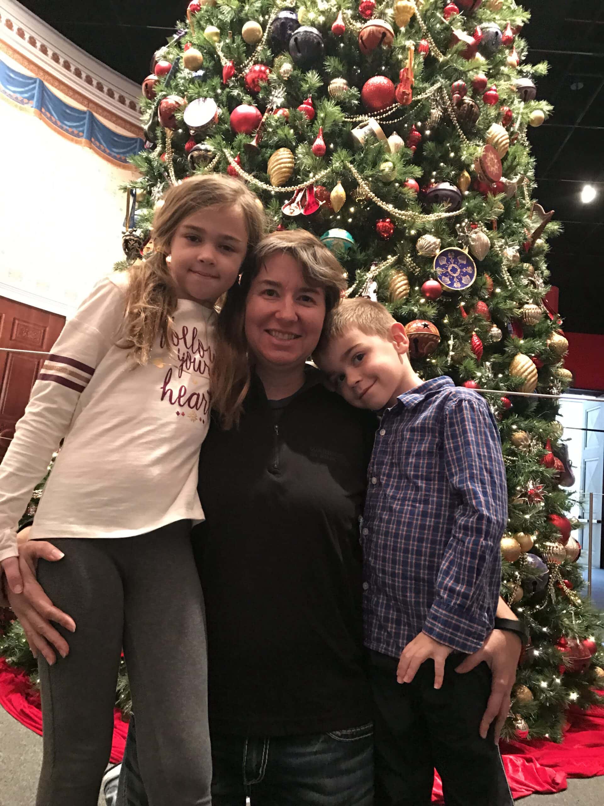 kids in front of Christmas tree