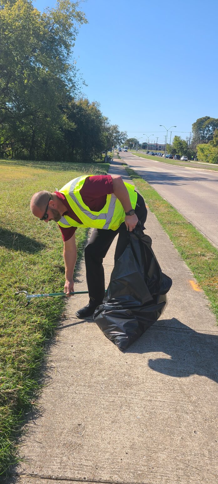 man picking up garbage