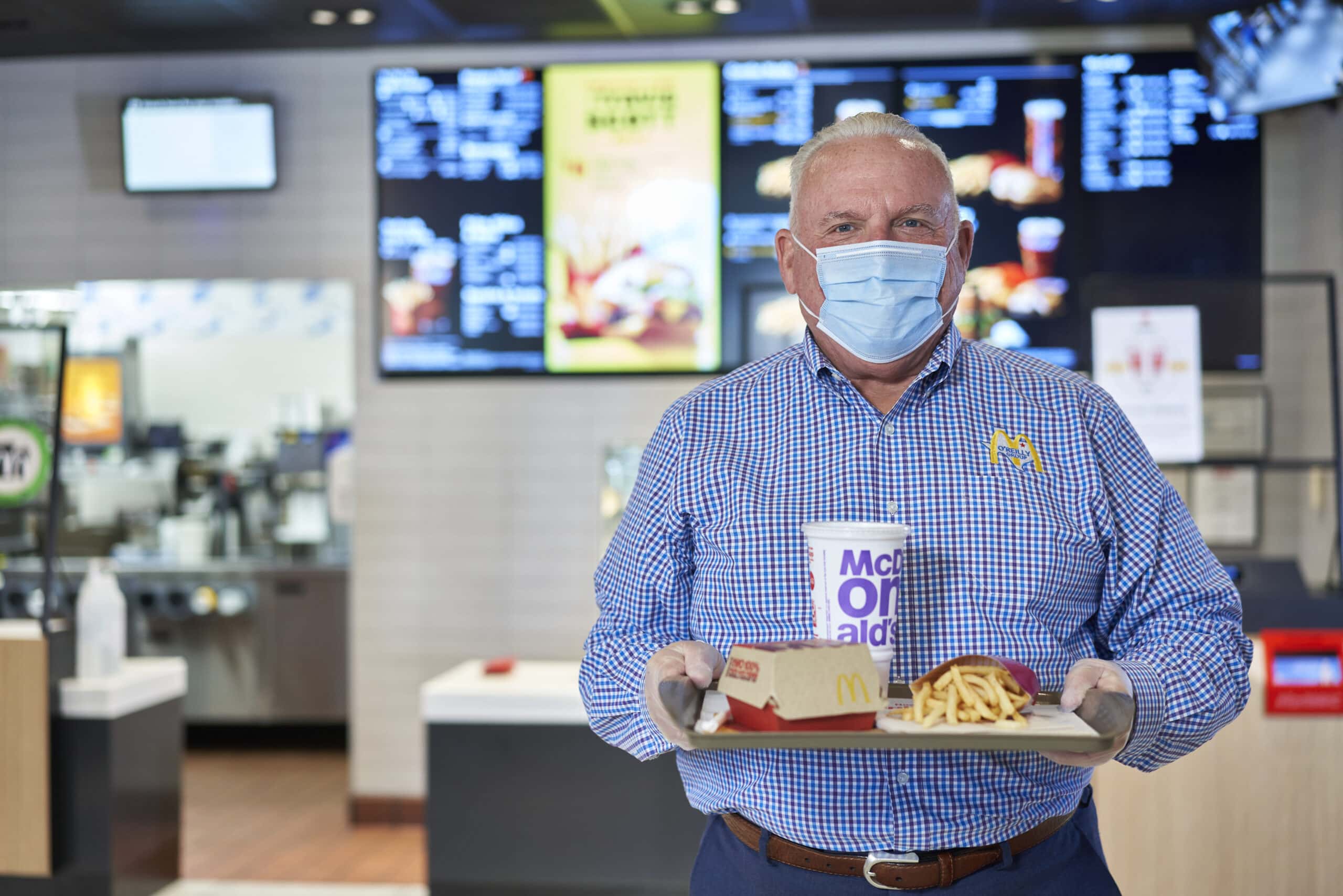 man holding tray of McDonalds food