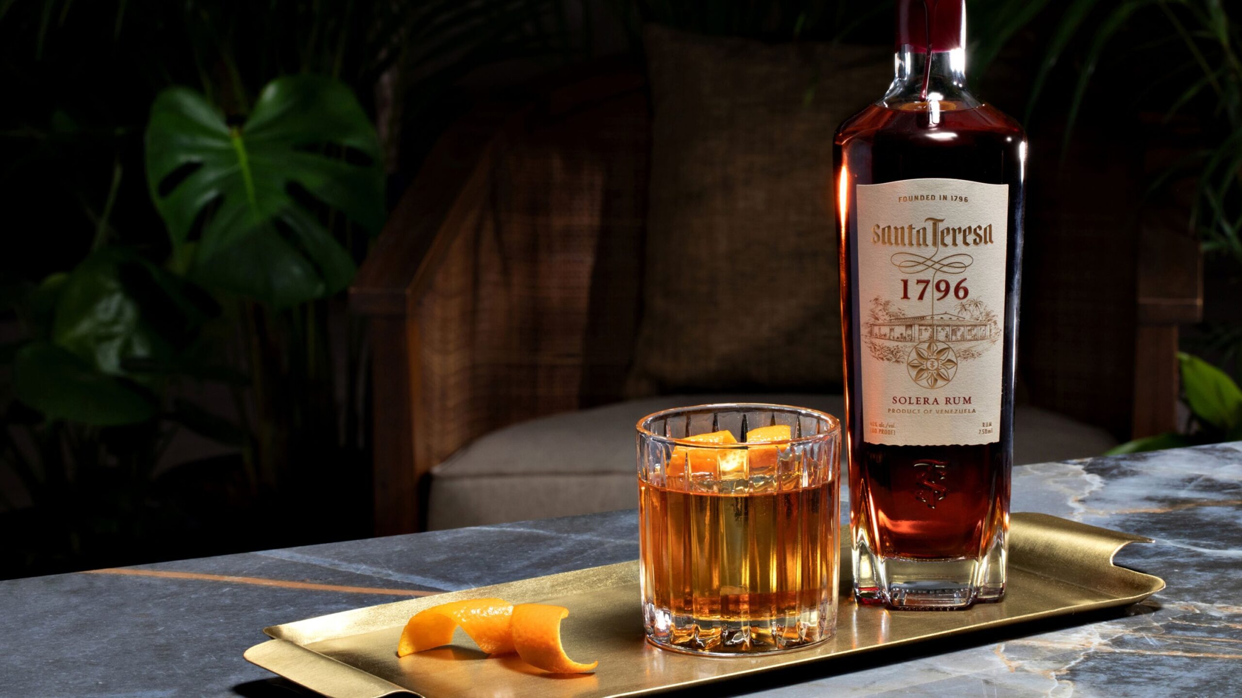 old fashioned in glass with bottle of Saint Teresa