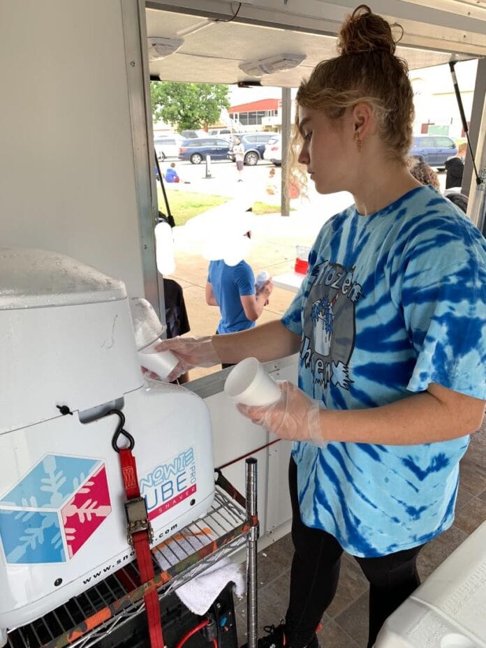 girl making a snowcone