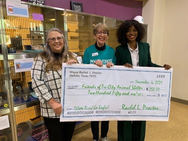 three ladies holding a cardboard check