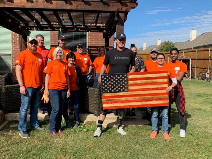 group of people holding wooden flag