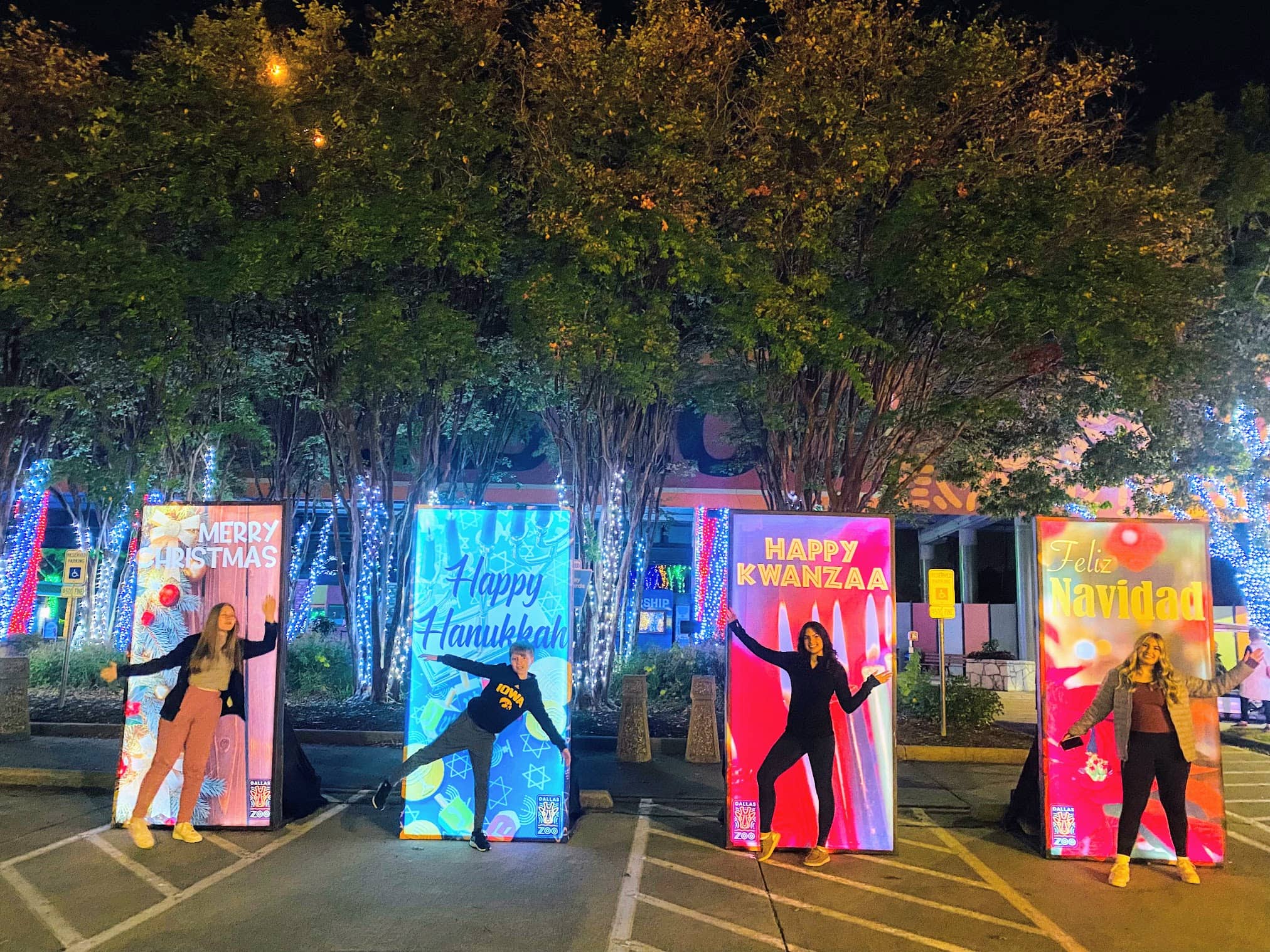 kids posing in front of holiday signs