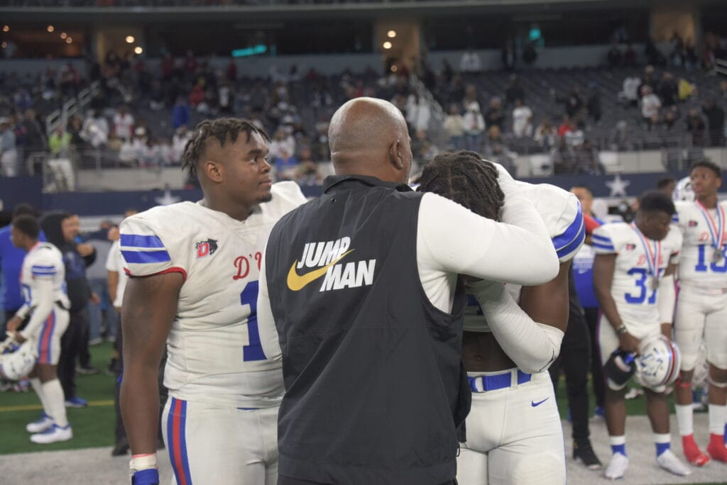 Coach Samples hugs player