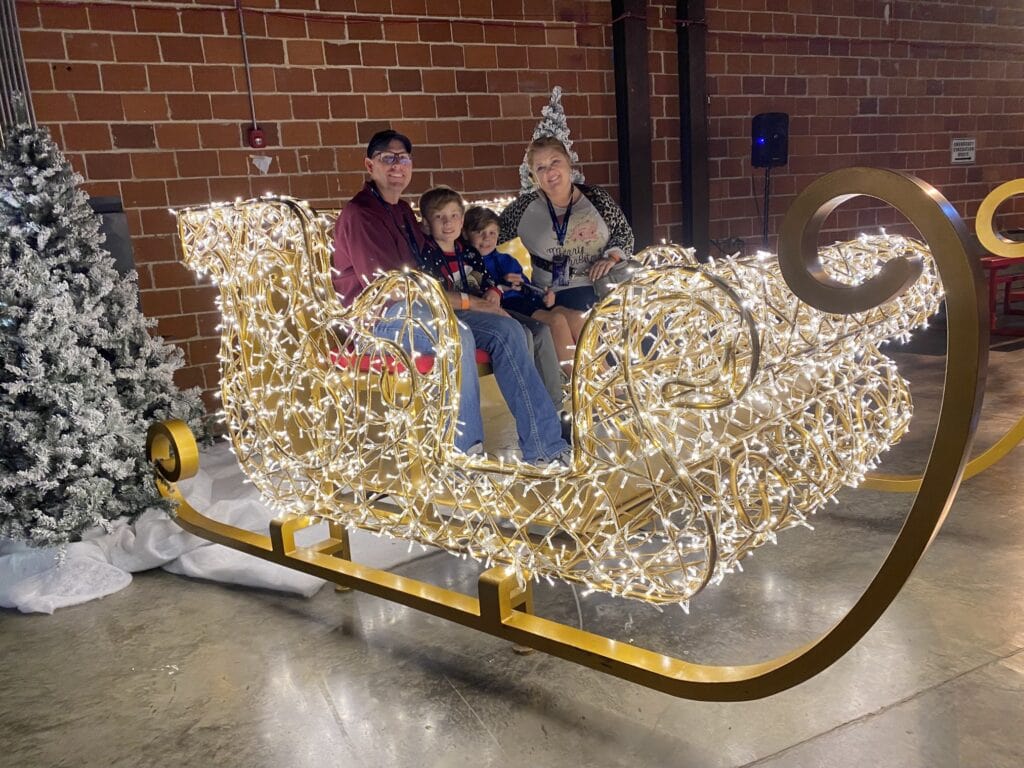 family sitting in sleigh