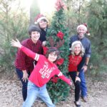 Midlothian Family Celebrates December Birthday With Gifts of Hope kids with adults by Christmas tree