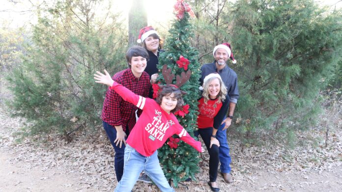 Webber family kids with adults by Christmas tree