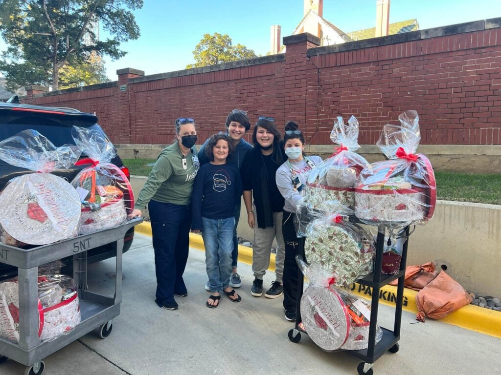 family with gift baskets