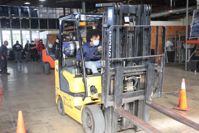 student on forklift