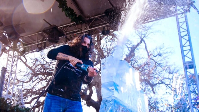 guy cutting ice with chainsaw