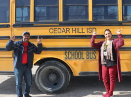 two people by school bus